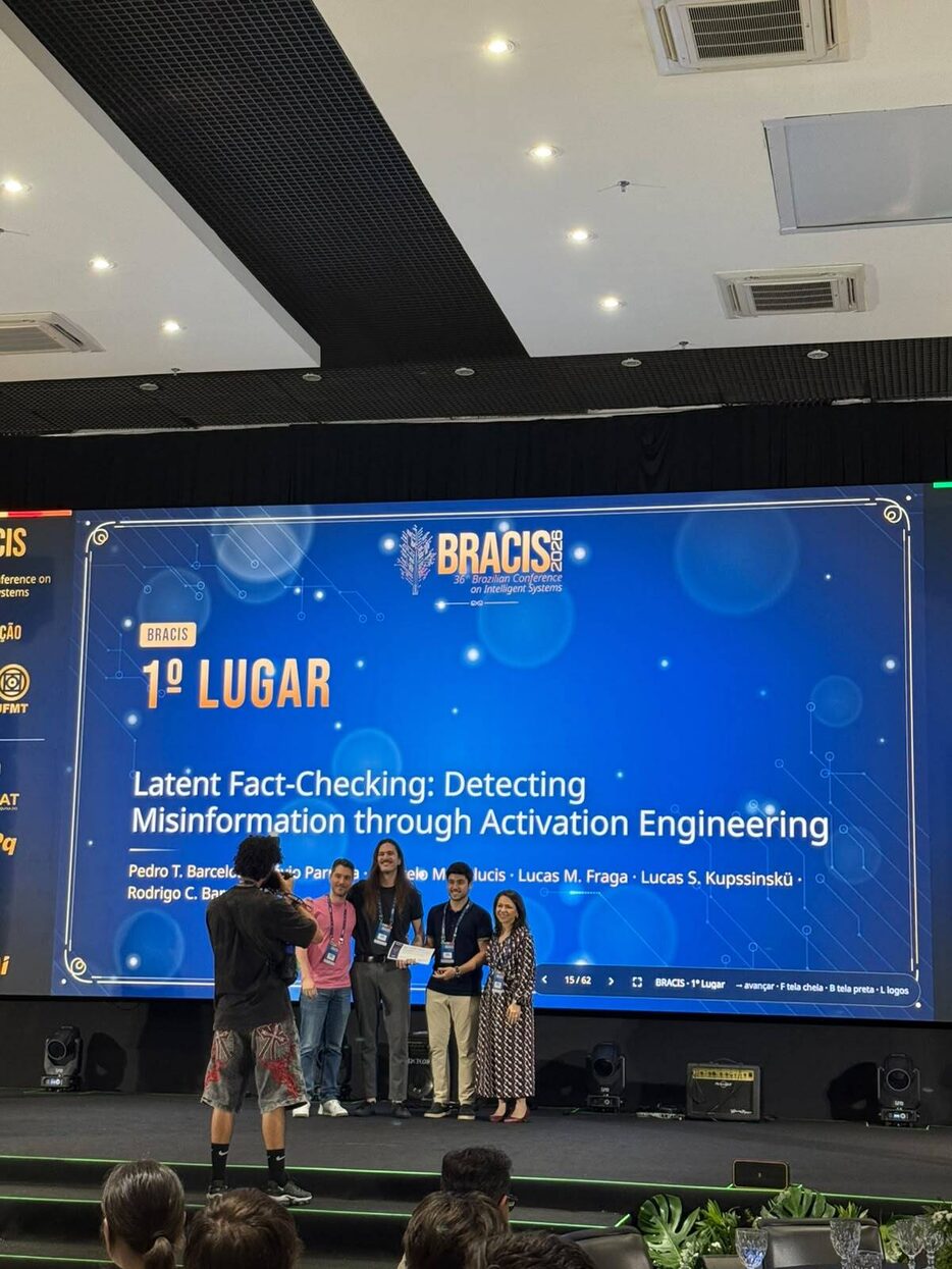 Authors on stage at BRACIS 2026 receiving the Best Paper Award, with a slide reading first place and the title Latent Fact-Checking